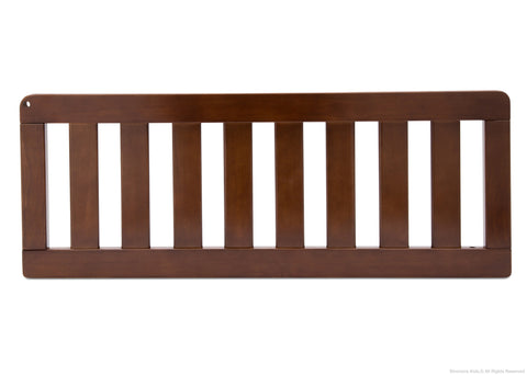A medium brown wooden crib rail with 9 vertical slats.